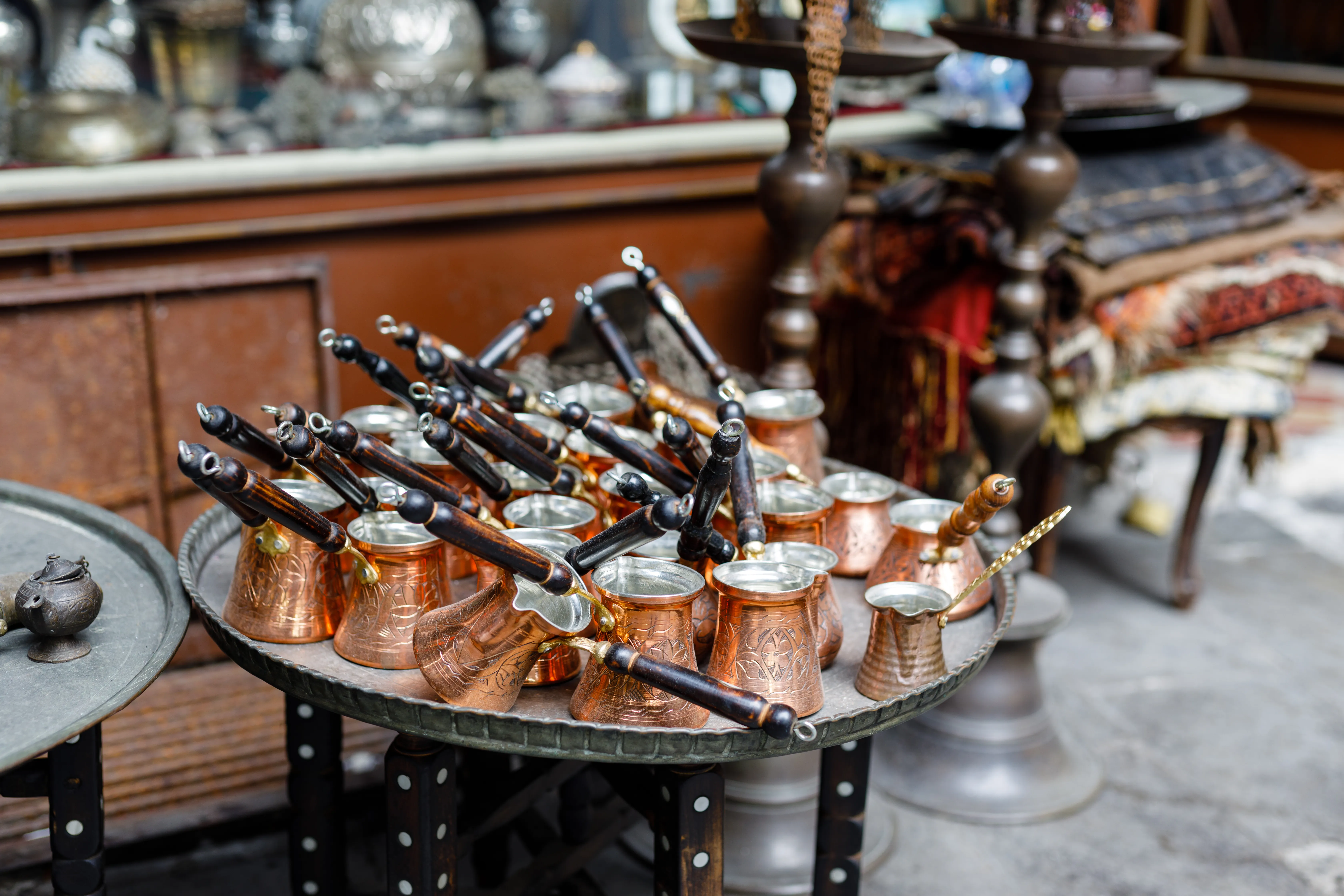 Hand-hammered copper Turkish coffee pots (cezve) for sale at a street market