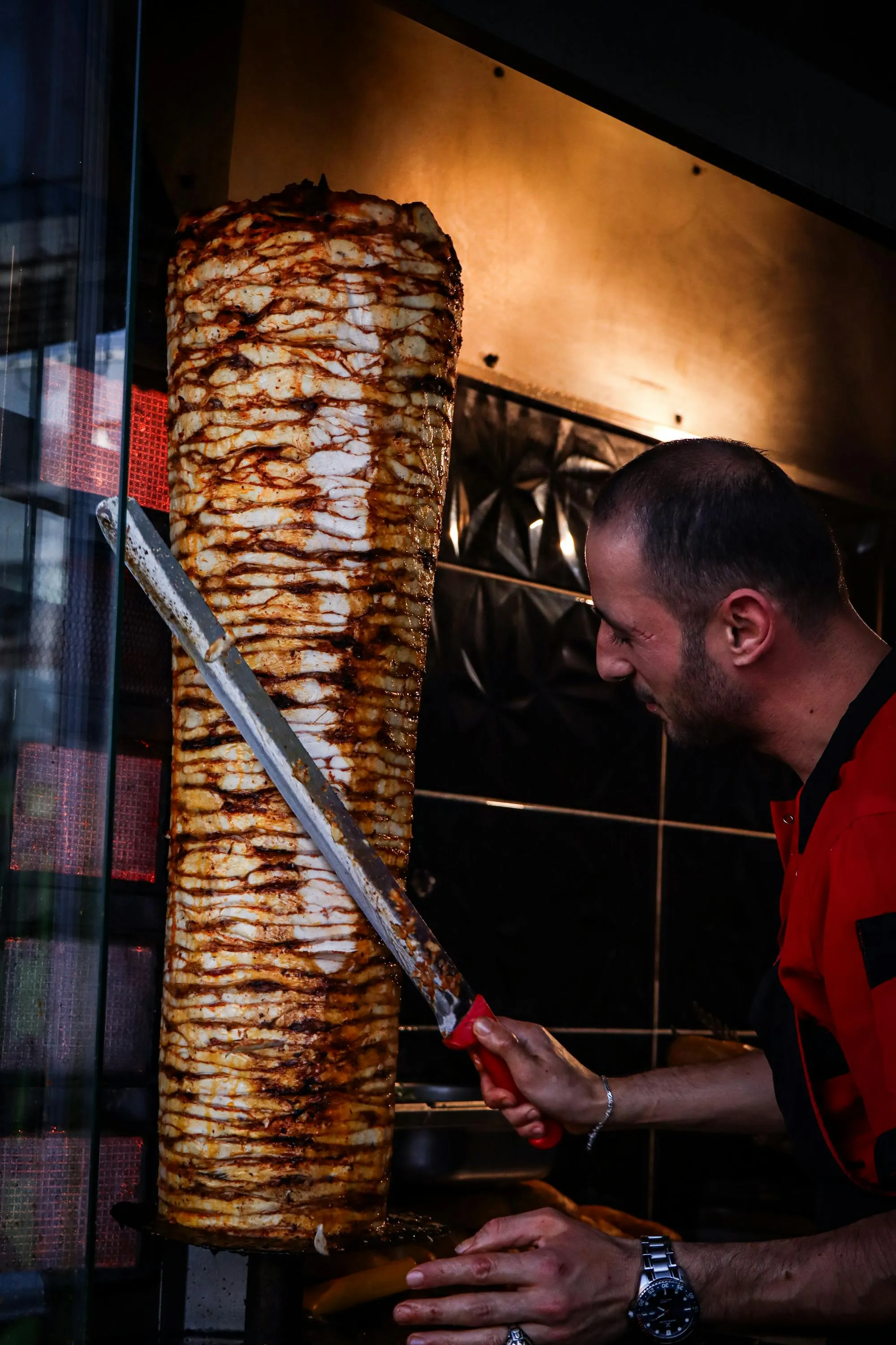 Close-up of a cooked Turkish döner kebab, thinly sliced and ready to serve