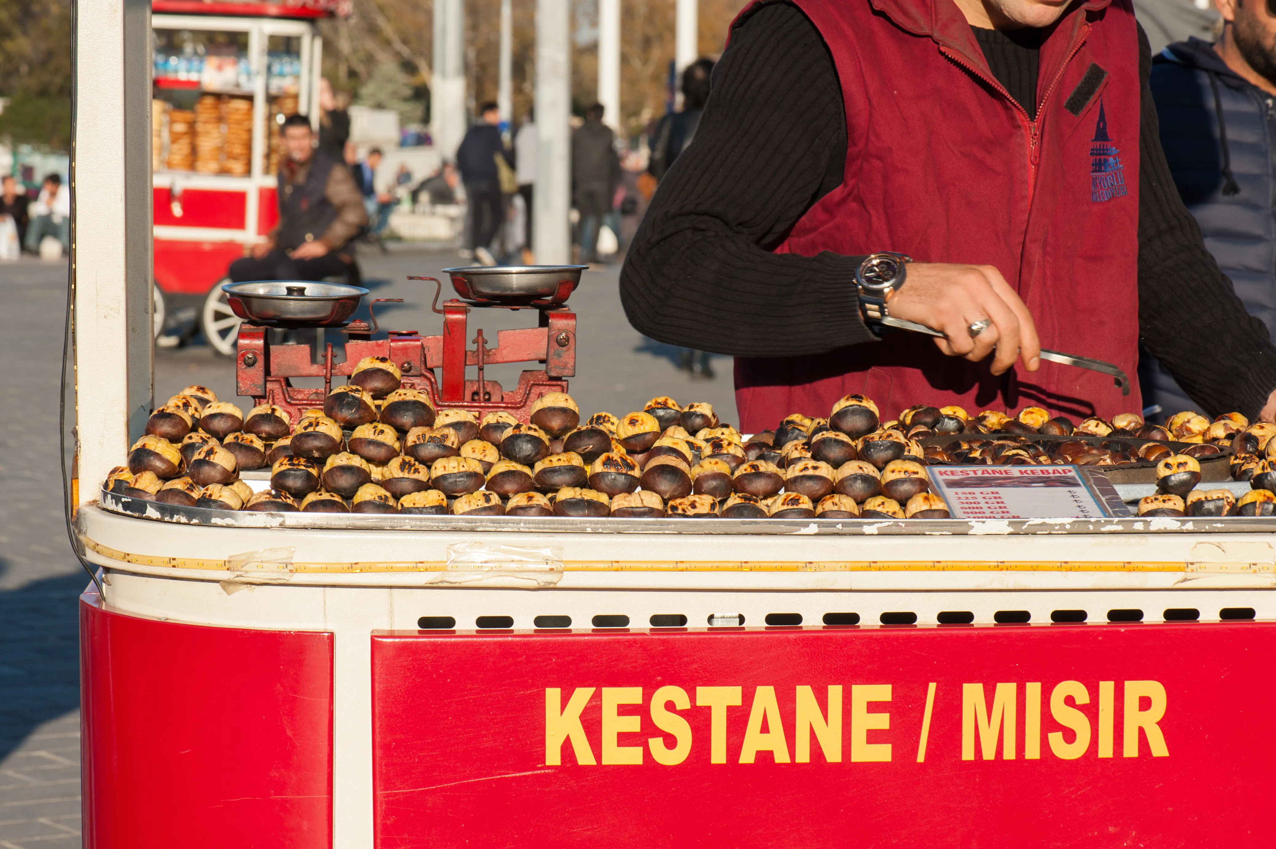 A traditional Istanbul kestane vendor at his iconic red chestnut cart in Taksim Square