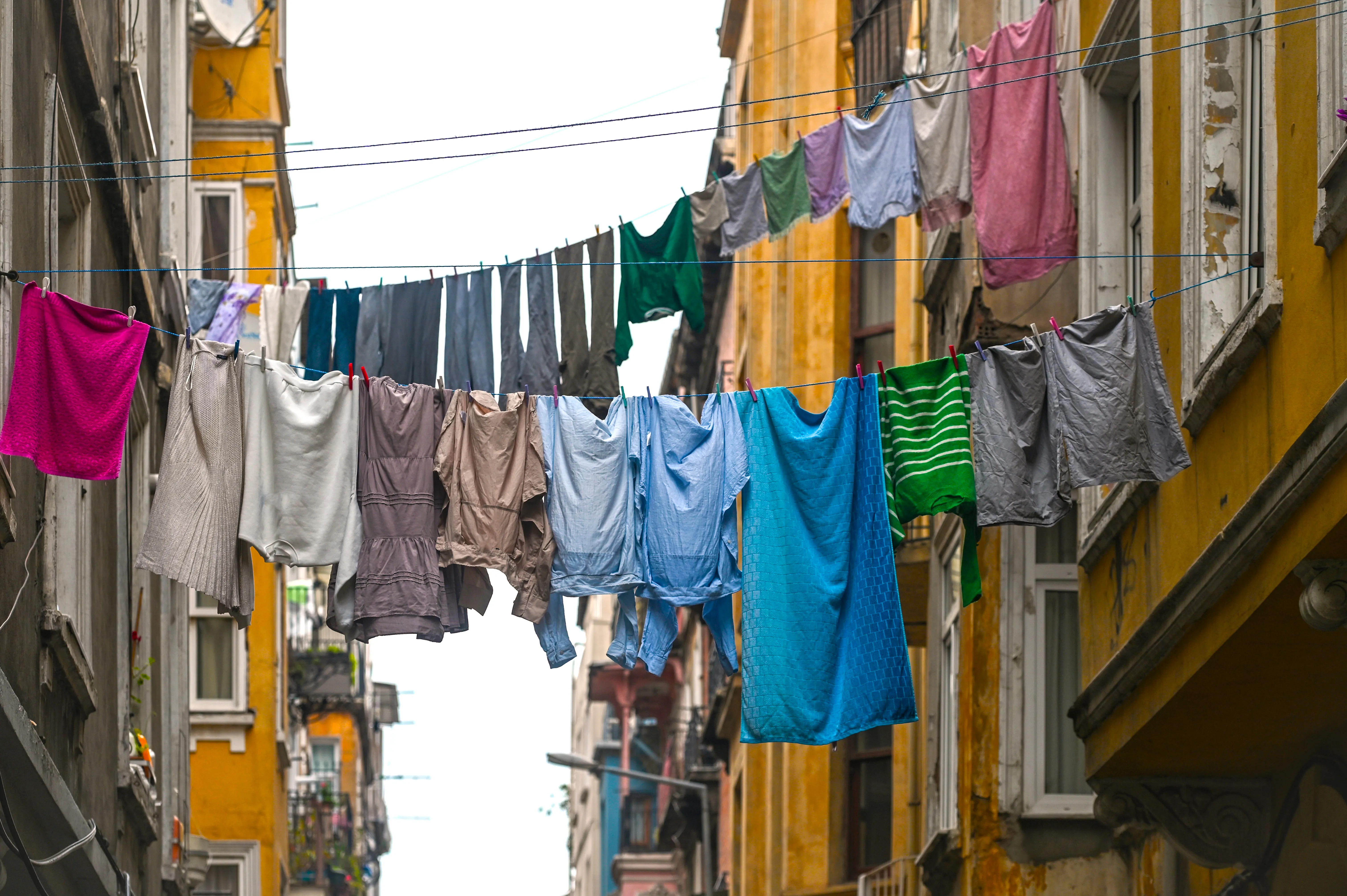 Laundry and clothes drying on a rope strung across an old Istanbul residential street