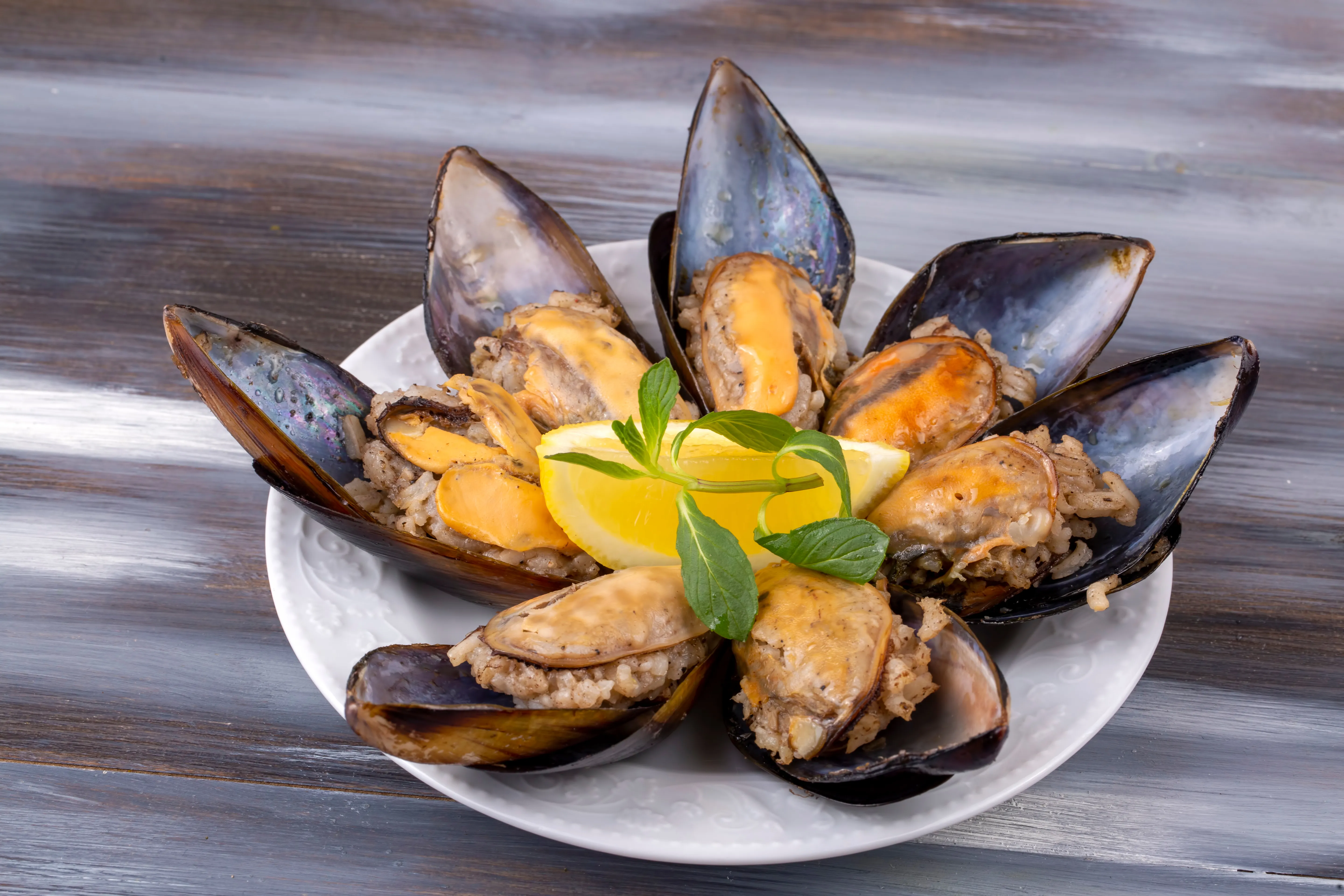 A plate of Turkish midye dolma, mussels stuffed with spiced rice