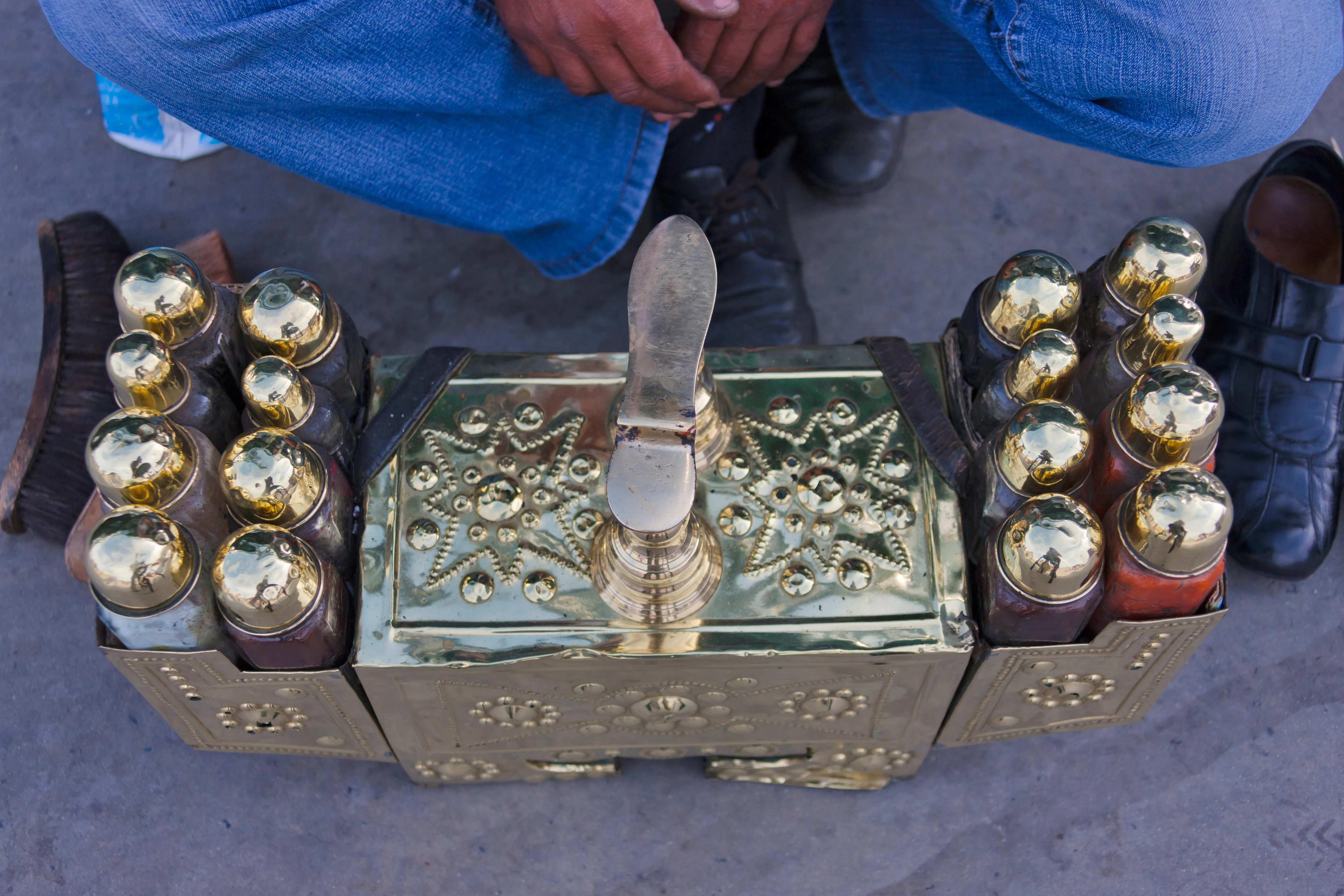 A traditional ornate silver-and-brass Istanbul shoe-shine box on a city street