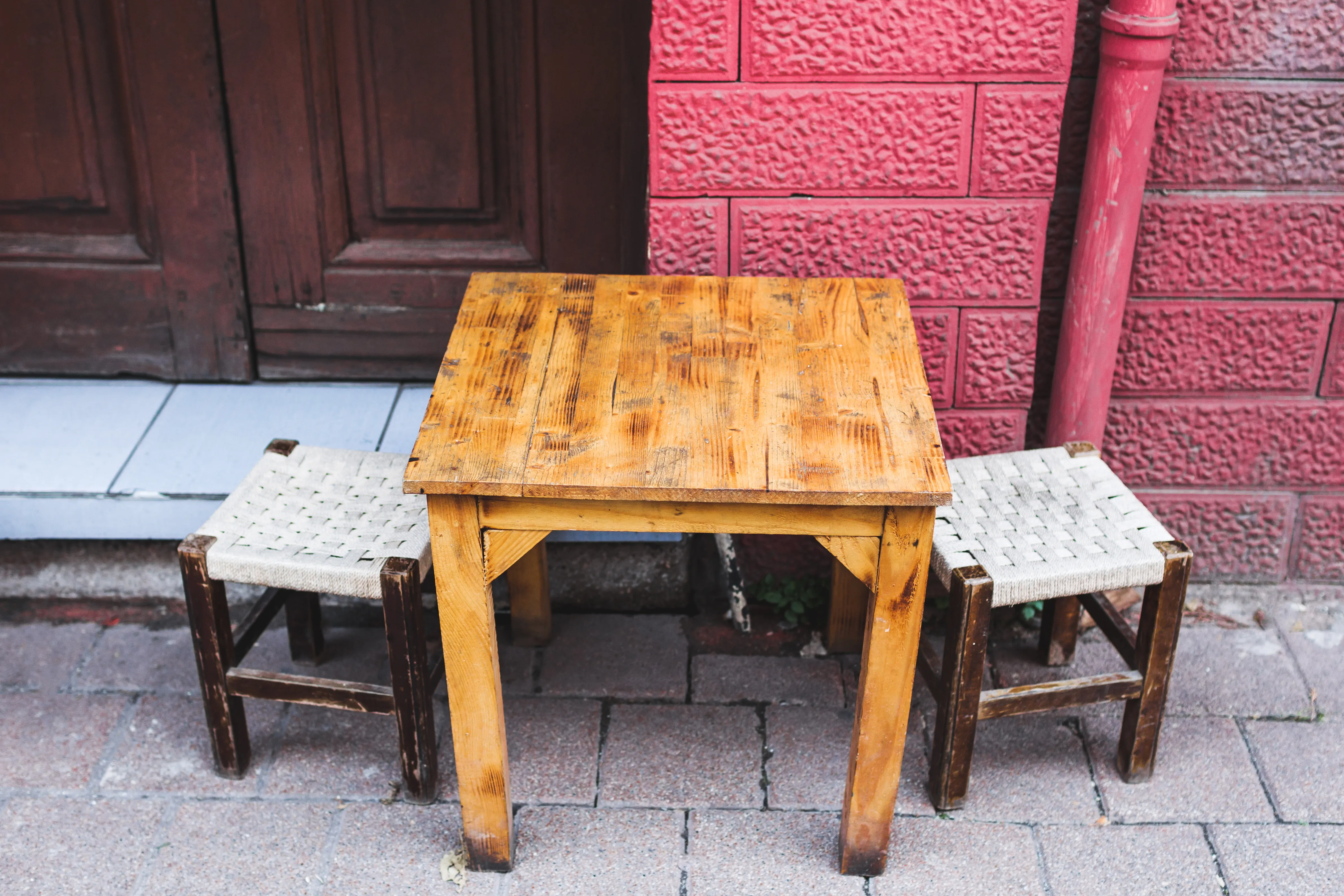A traditional Turkish street café with small wooden stools and a low table set out on the pavement