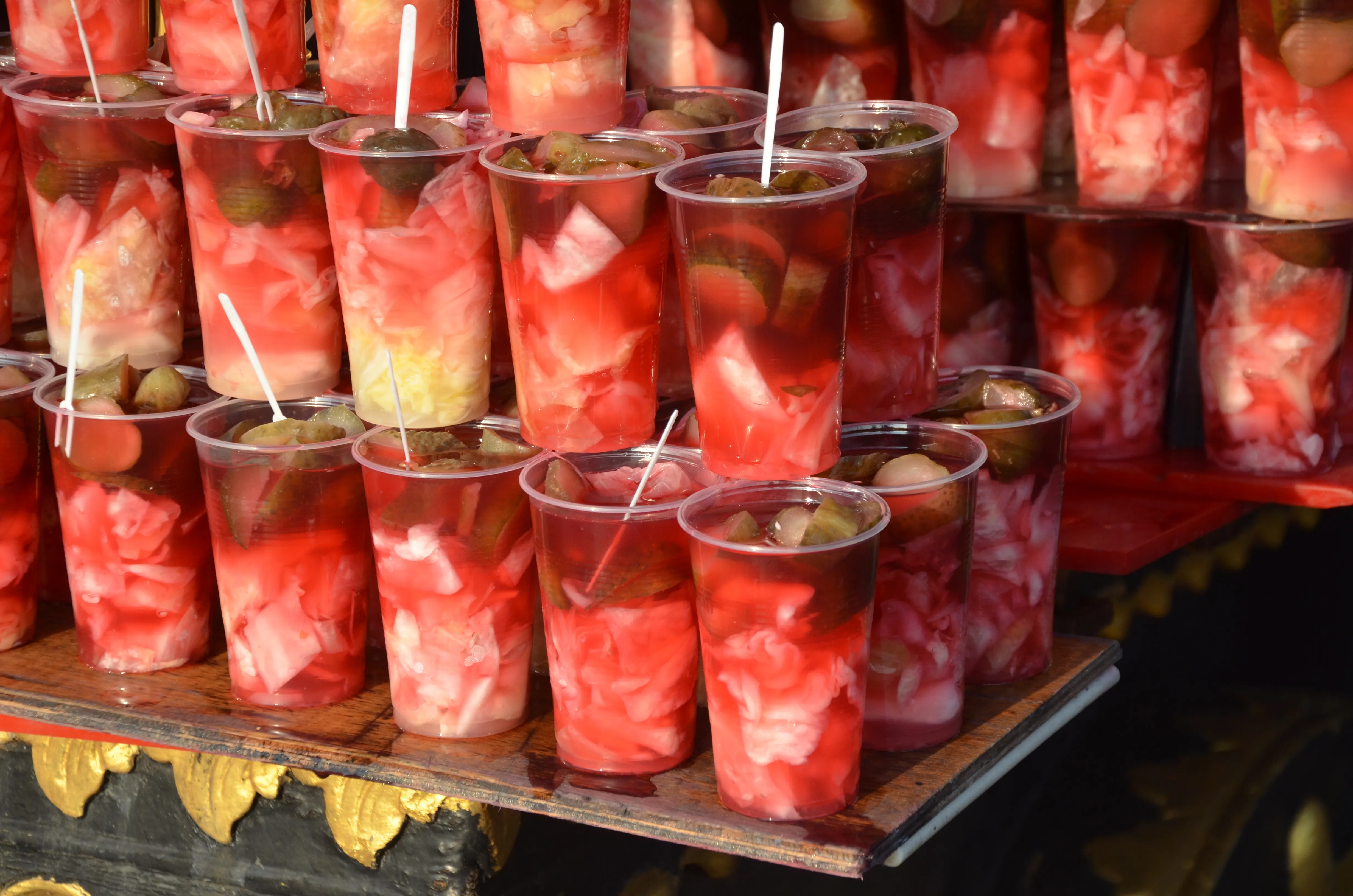 Glasses of bright red turşu suyu, traditional Turkish pickle juice, sold at a street stall near Eminönü